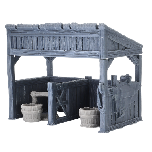 Unpainted Castle Stables terrain set in grey PLA plastic, showing the front view of the medieval stable building with accessories.