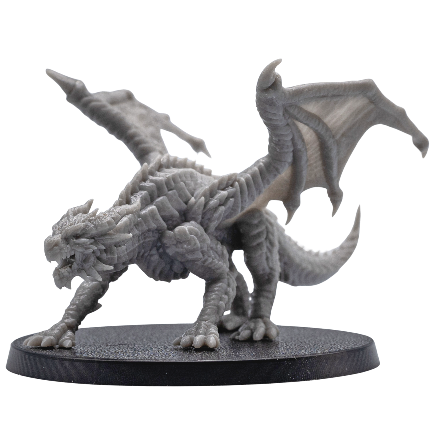 Action pose view of an unpainted Young Red Dragon miniature with raised wings, open jaws, claws, and detailed fantasy creature sculpt.
