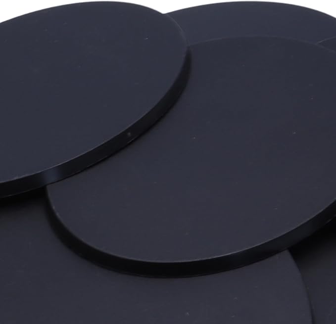 Close-up of black 120mm x 92mm oval plastic miniature bases showing textured top surfaces for large wargaming models, RPG monsters, vehicles, conversions, and scenic basing projects.