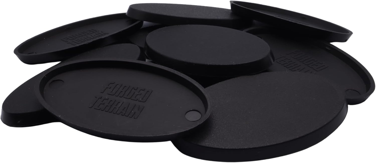 Close-up of black 60mm x 35mm oval plastic miniature bases showing textured top surfaces for cavalry models, mounted figures, bikes, conversions, and hobby basing projects.