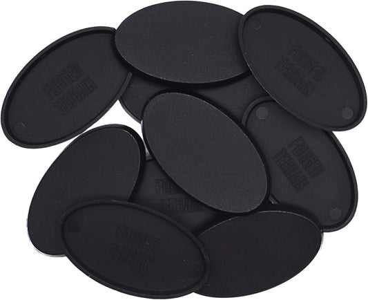 Close-up of black 75mm x 45mm oval plastic miniature bases showing textured top surfaces for cavalry models, mounted figures, wargaming, conversions, and hobby basing projects.