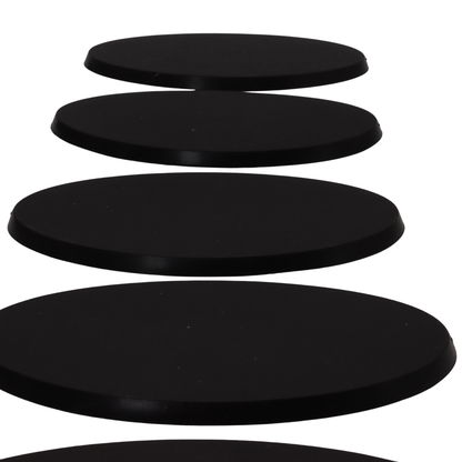 Side profile of black 90x52mm oval bases showing the approximately 4mm base height.