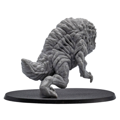 Back angle view of an unpainted Aberration fantasy monster miniature showing detailed organic sculpting, tail section, and oval base.