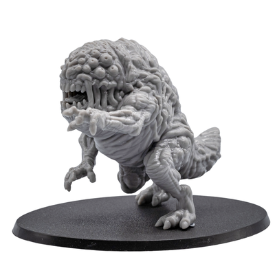 Side view of an unpainted Aberration resin miniature showing muscular body texture, extended claw, rear tail section, and oval base.