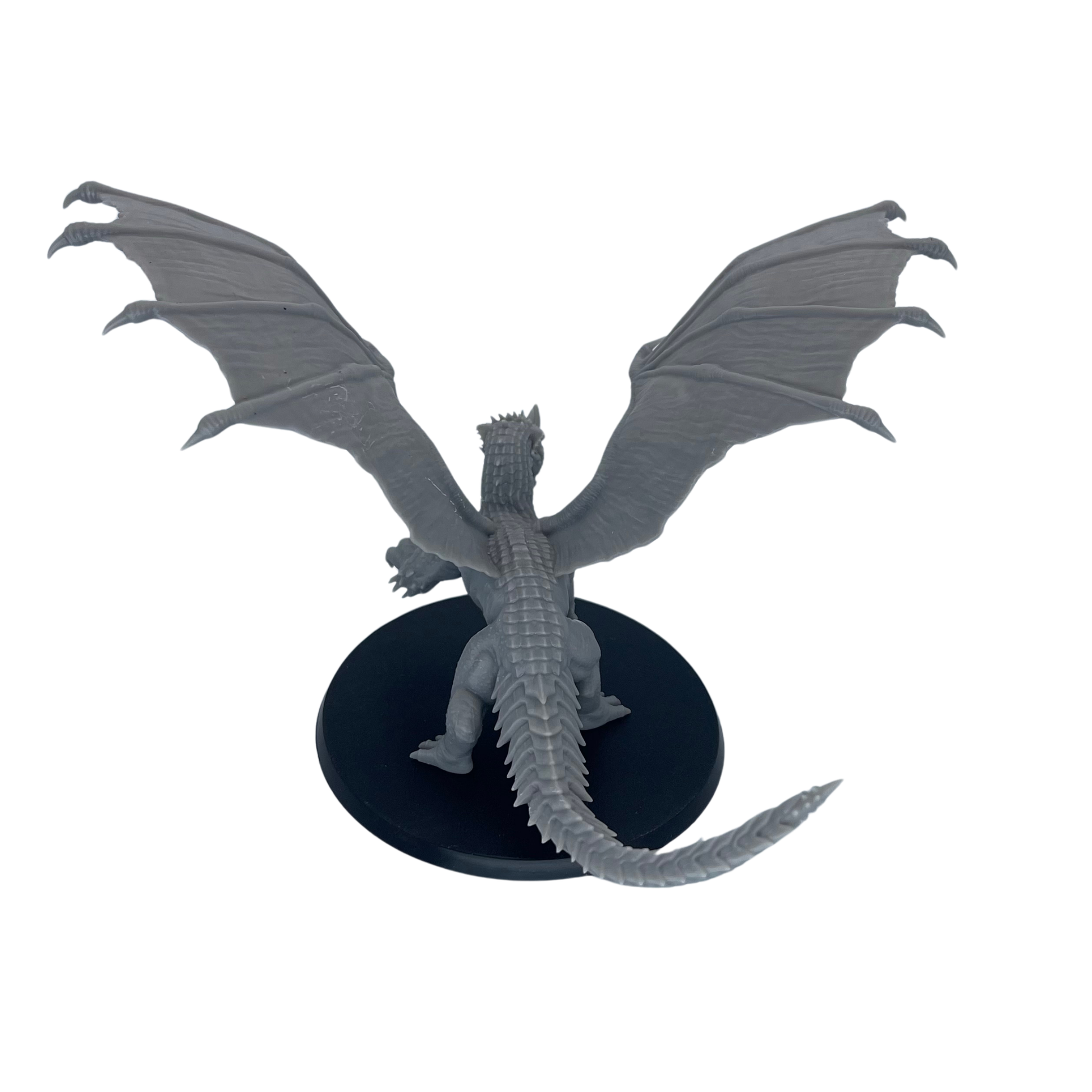 Rear view of the unpainted Adult Blue Dragon showing the wide wingspan, back scales, and sweeping tail.
