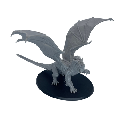 Unpainted Adult Blue Dragon shown from an angled side view displaying the scaled body, wings, and long tail.