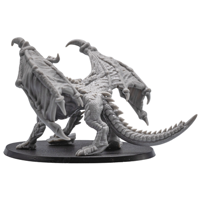 Left side view of the unpainted Adult Red Dragon miniature showing wing membrane, horns, claws, and tail.