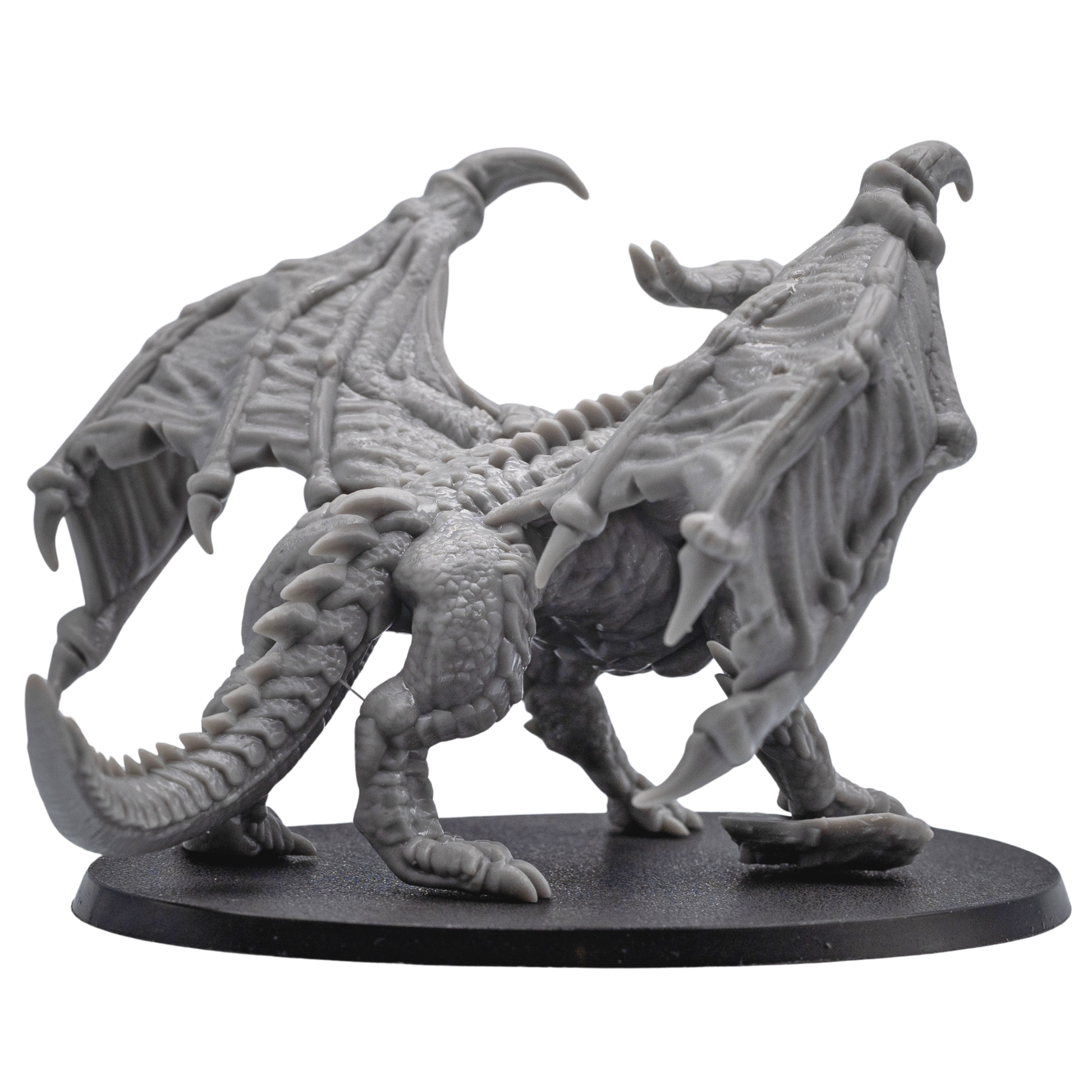Rear detail view of the unpainted Adult Red Dragon miniature showing wings, tail, scales, and spine details.