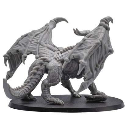 Rear detail view of the unpainted Adult Red Dragon miniature showing wings, tail, scales, and spine details.