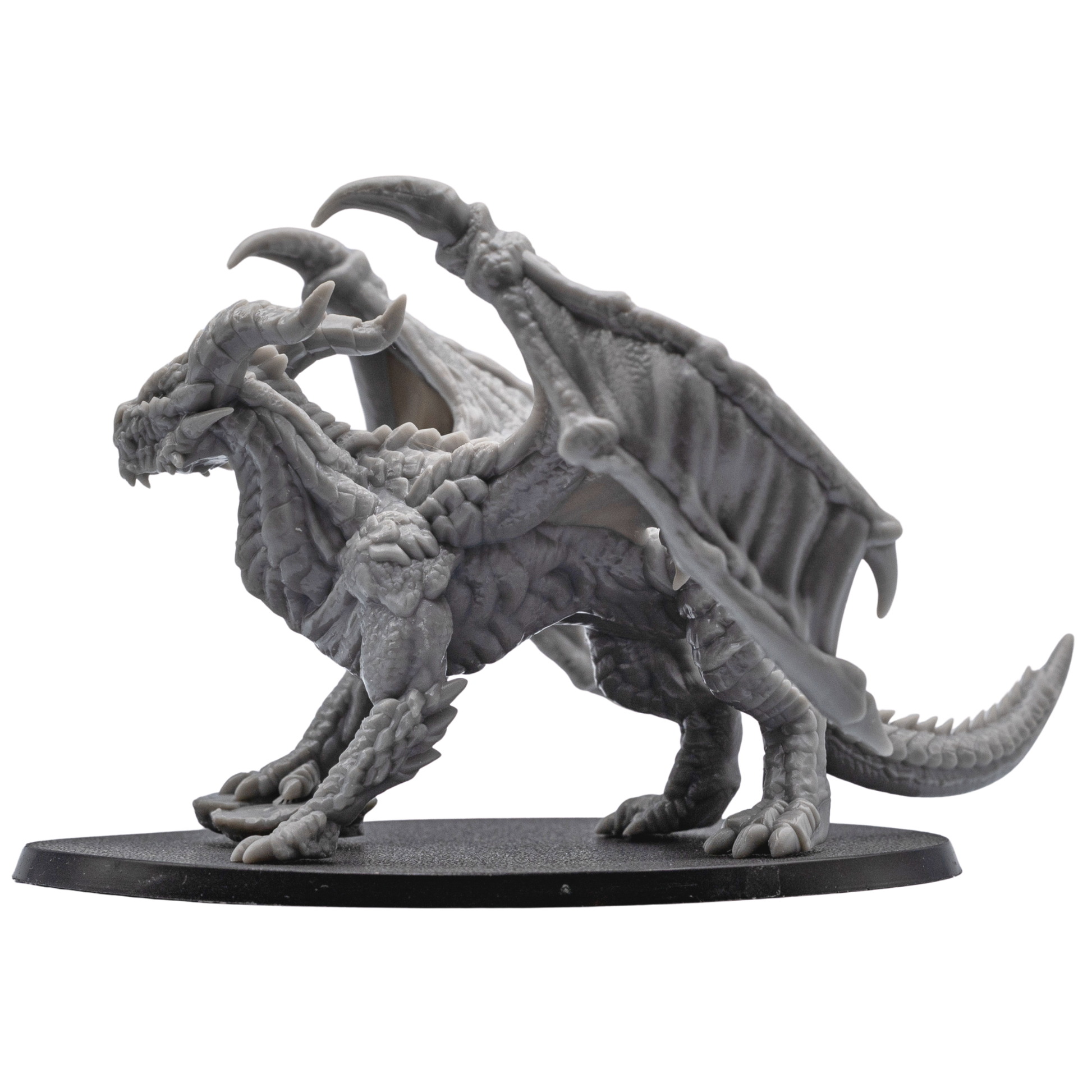 Three-quarter view of the unpainted Adult Red Dragon miniature with wings spread and claws raised.