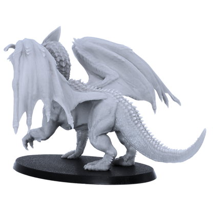 Back angle view of the Adult White Dragon miniature showing folded wings, long scaled tail, rear sculpting, and 90mm x 52mm oval base.