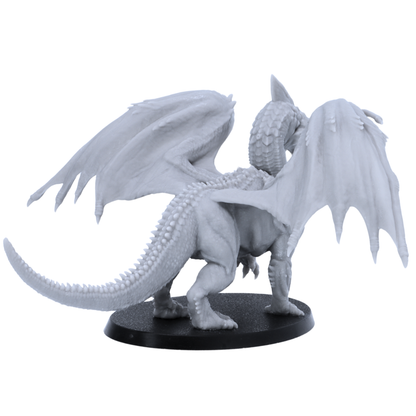 Rear side view of an unpainted Adult White Dragon miniature showing wing membrane detail, scaled tail, rear body texture, and oval base.