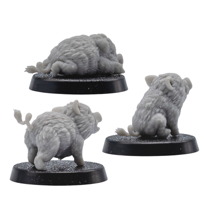 Back angle view of three unpainted Baby Boar Familiar resin miniatures showing rear fur texture, curled tails, and 25mm round bases.
