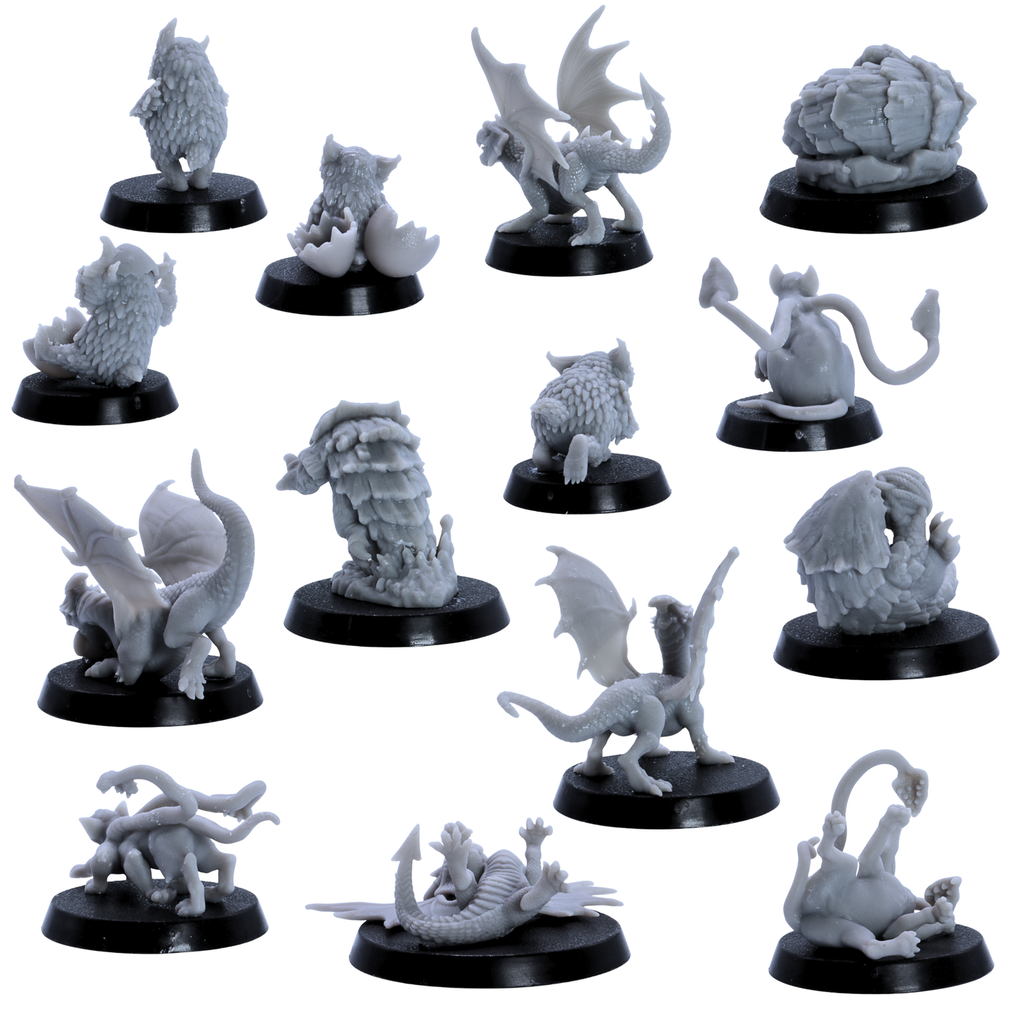 Rear views of unpainted Baby Dragons and Monsters miniatures showing sculpted wings, tails, feathers, shells, and creature details.