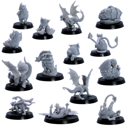 Rear views of unpainted Baby Dragons and Monsters miniatures showing sculpted wings, tails, feathers, shells, and creature details.