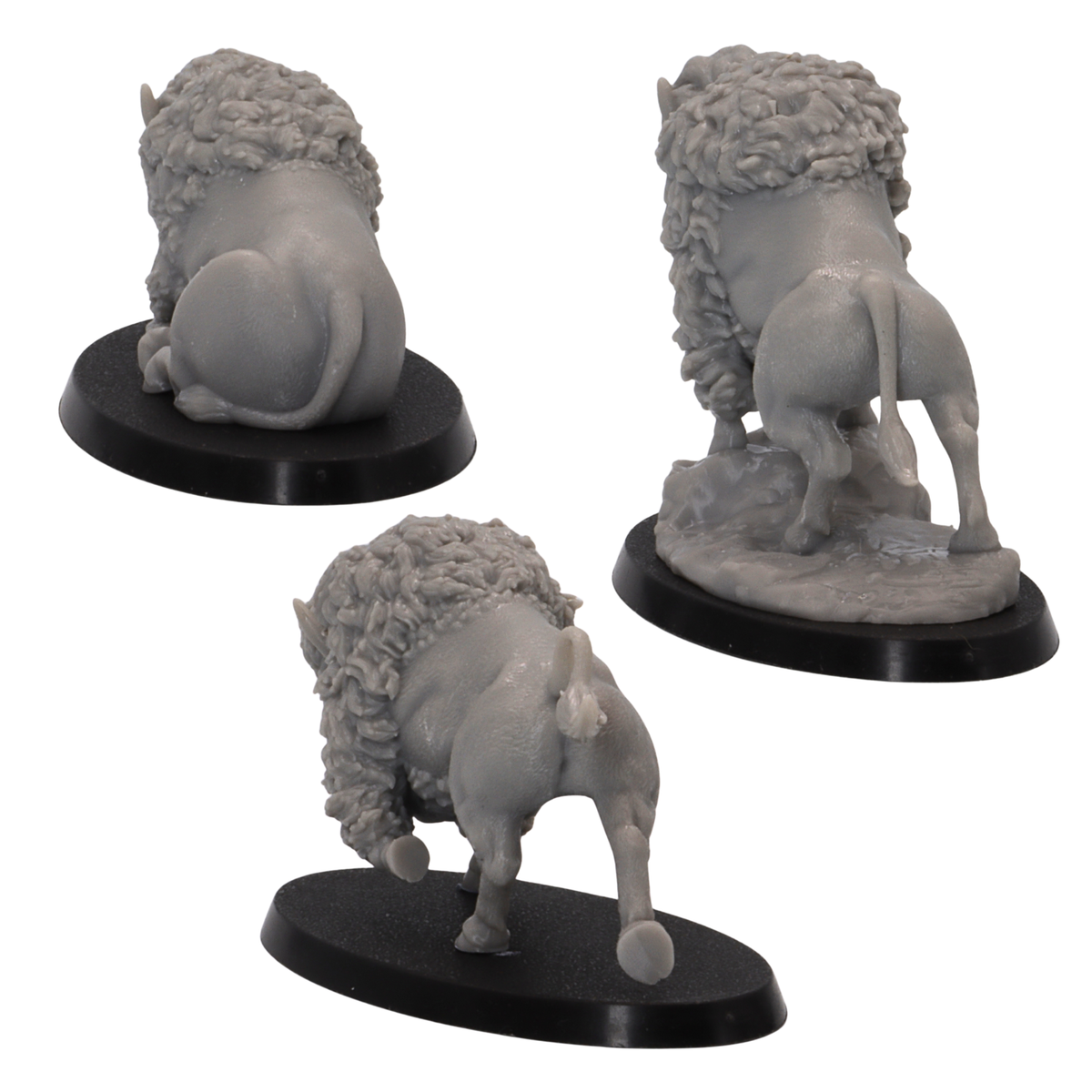 Three unpainted resin Bison miniatures in different poses