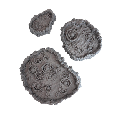 Top view of three bubbling toxic pit terrain pieces showing pools and rocky edges