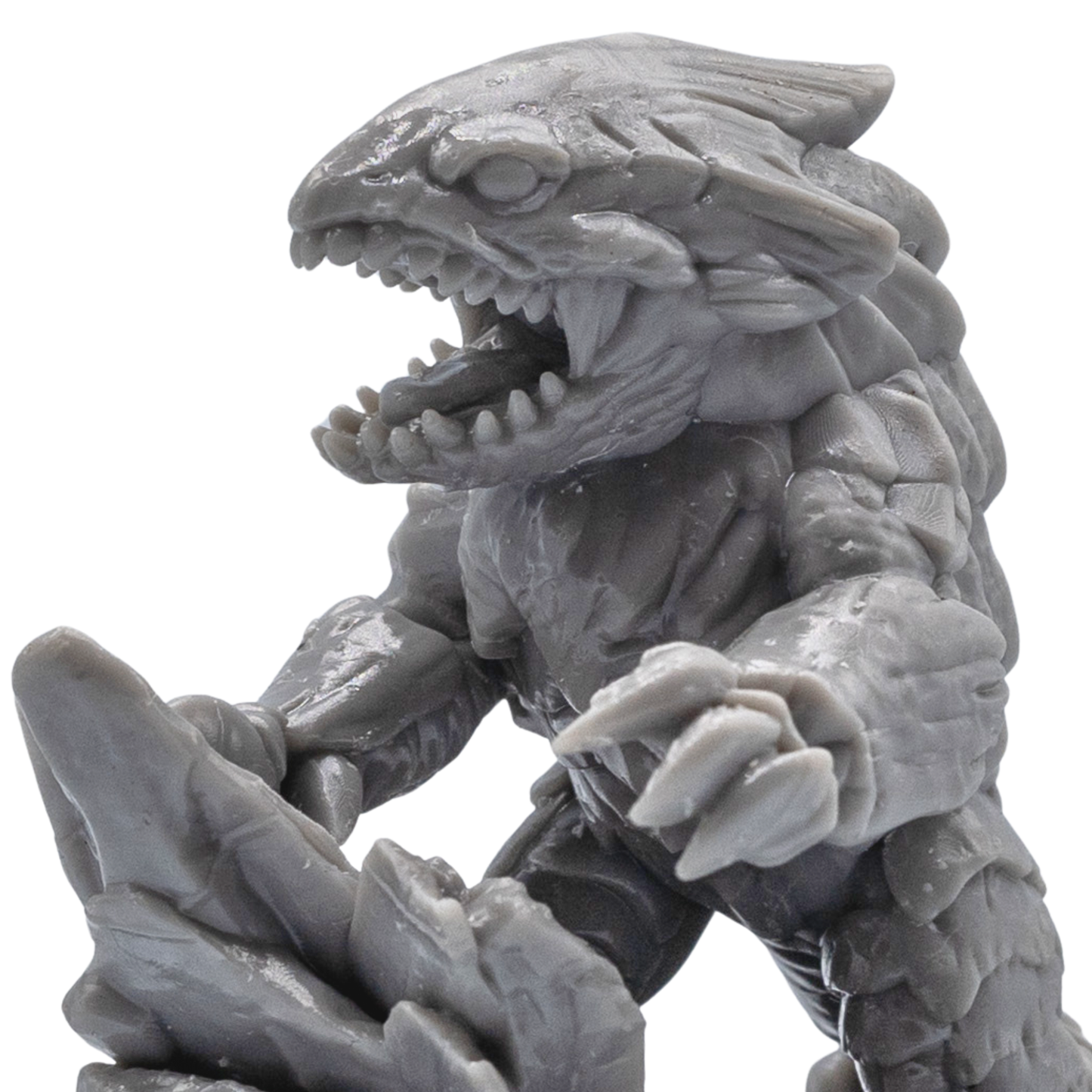 Close-up of an unpainted Bulette resin miniature showing sharp teeth, claws, armor plates, and detailed creature sculpting.