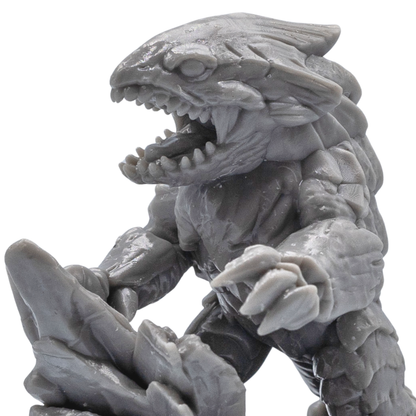 Close-up of an unpainted Bulette resin miniature showing sharp teeth, claws, armor plates, and detailed creature sculpting.