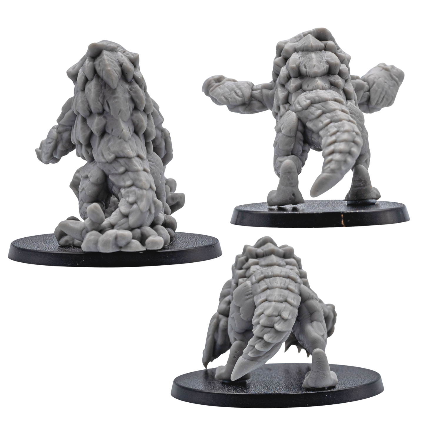 Rear views of unpainted Bulette miniatures showing armored backs, tails, rocky details, and creature sculpt texture.