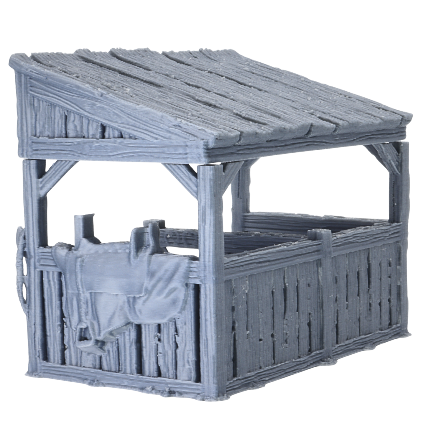 Side view of Castle Stables terrain showing wooden stable walls, sloped roof, and saddle detail hanging on the exterior.