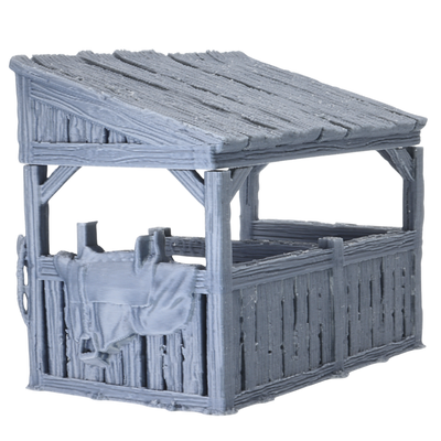 Side view of Castle Stables terrain showing wooden stable walls, sloped roof, and saddle detail hanging on the exterior.