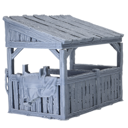 Side view of Castle Stables terrain showing wooden stable walls, sloped roof, and saddle detail hanging on the exterior.