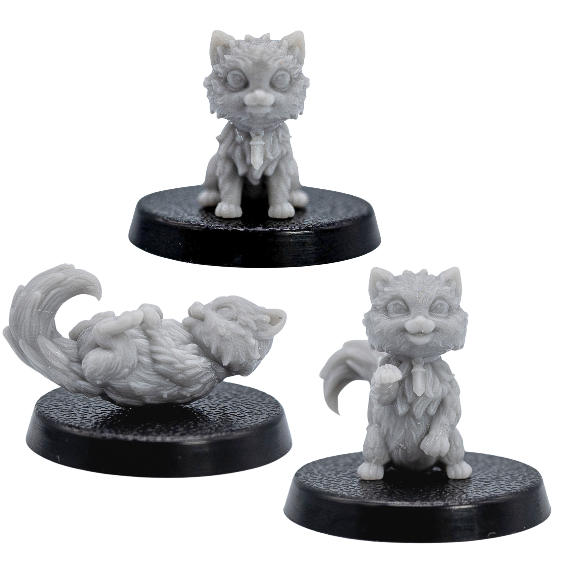 Unpainted Cat Familiars miniatures showing sitting, standing, and playful lying poses.