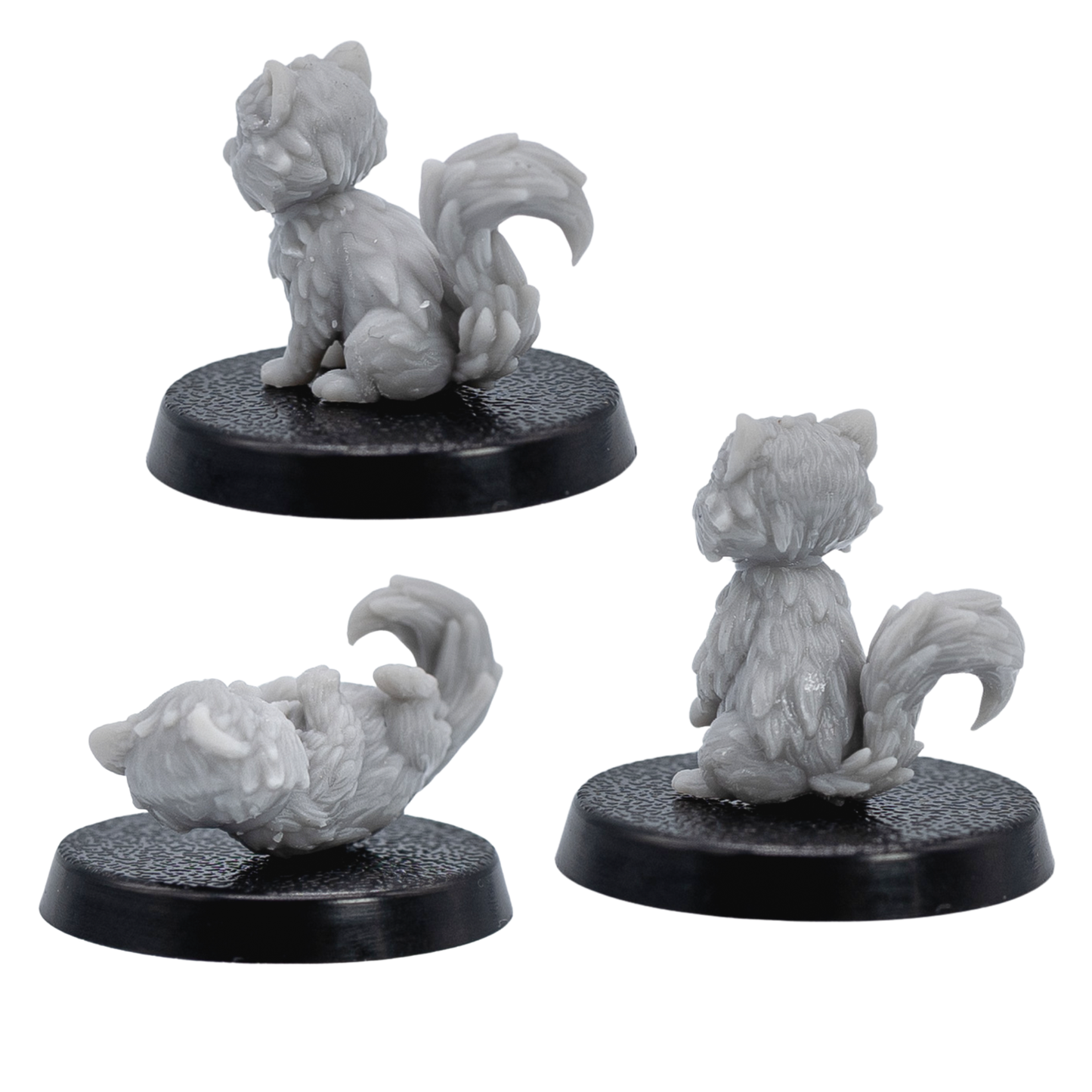 Rear views of the unpainted Cat Familiars miniatures showing sculpted tails and fur detail.