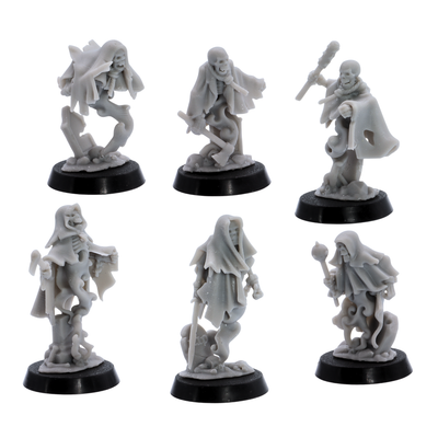 Unpainted Crypt Ghost miniatures showing six varied undead spirit poses with skeletal faces, torn cloaks, weapons, and spectral bodies.