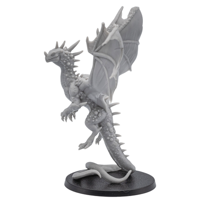 Left side view of an unpainted Crystal Dragon resin miniature showing wings, claws, crystal body details, and curled tail on a round base.