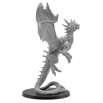 Side view of an unpainted Crystal Dragon miniature showing wide wings, upright pose, long curling tail, and crystal body texture.