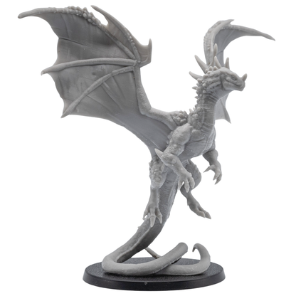 Front side view of an unpainted Crystal Dragon resin miniature by Epic Miniatures showing raised wings, long tail, claws, and round base.
