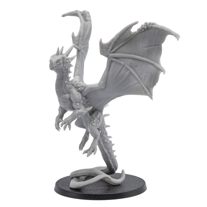 Rear wing detail view of an unpainted Crystal Dragon miniature showing large wing membranes, spine texture, and upright dragon pose.