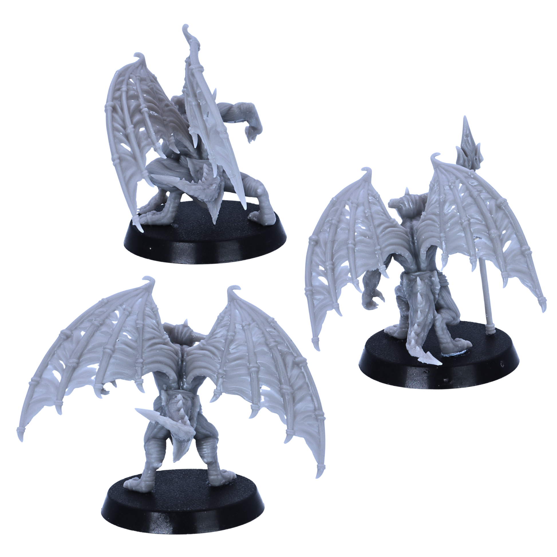Rear views of the unpainted Devil Minions miniatures showing bat-like wings, tails, and spear details.