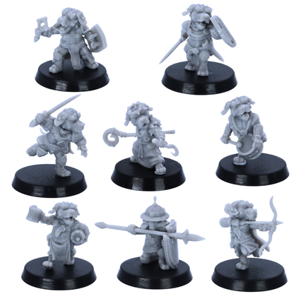 Unpainted Dog Folk miniatures showing eight fantasy canine adventurers with weapons, shields, bow, spear, drum, and robes.