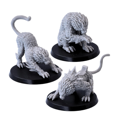 Three unpainted Draconic Cat miniatures by Epic Miniatures showing the different creature poses