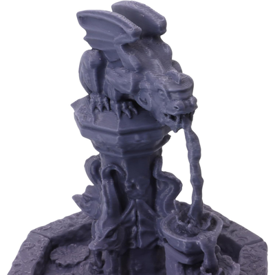 Close-up of the winged dragon statue perched above the fountain structure.