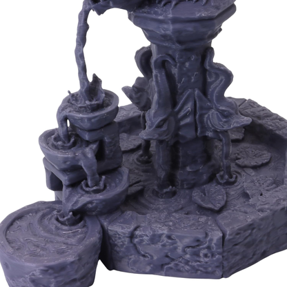Close-up view of the tiered fountain basins, flowing water channels and ornate stone textures.