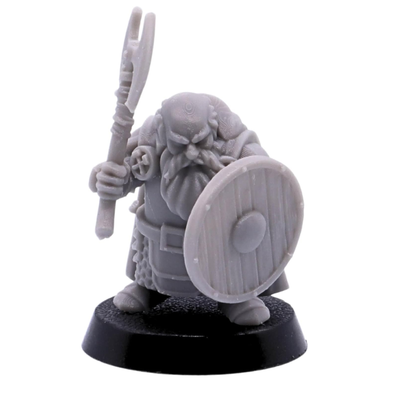 Unpainted dwarf warrior miniature holding a polearm-style axe with round shield.