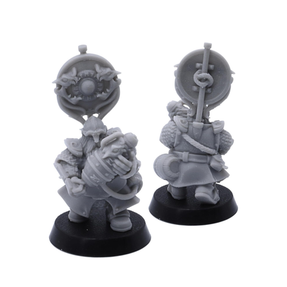 Unpainted Dwarf Fire Spitters banner miniature with shield and powder keg details shown from multiple angles.