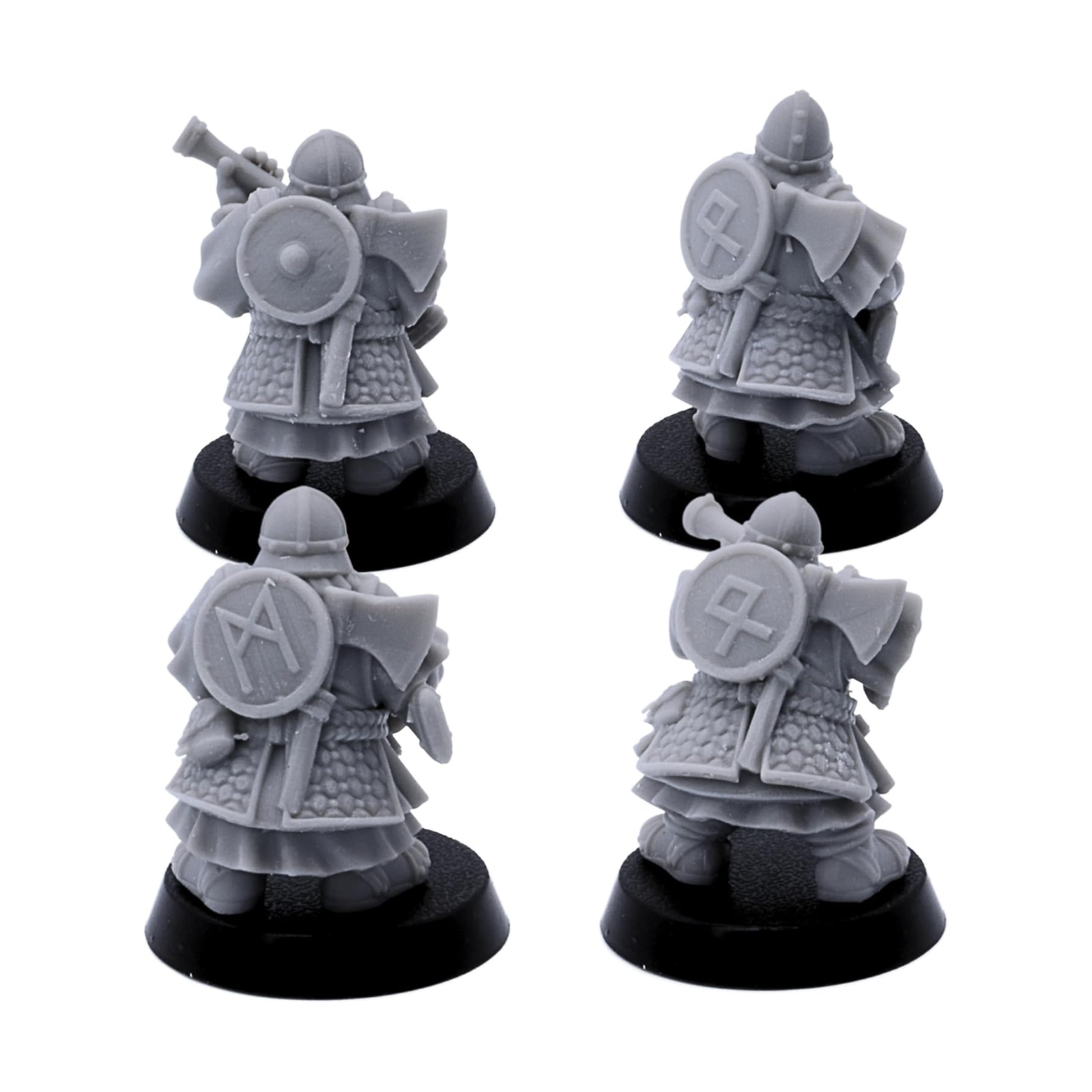 Rear views of unpainted Dwarf Gunners showing armour, shields, cloaks, and equipment details.