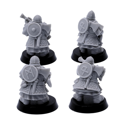 Rear views of unpainted Dwarf Gunners showing armour, shields, cloaks, and equipment details.