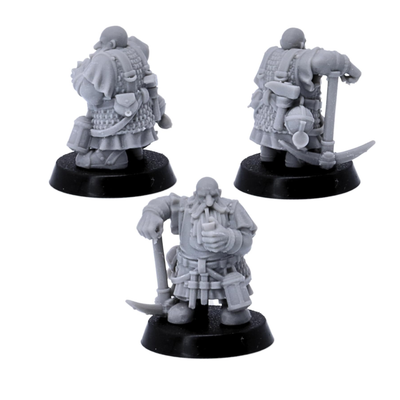 Rear views of unpainted dwarf miner miniatures showing armour, tools, belts, and mining equipment.