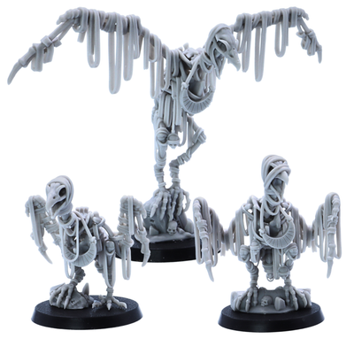 Group of three unpainted Egyptian Vulture miniatures with extended wings, bone details, wraps, and 40mm round bases.