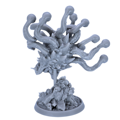 Unpainted Eye Tyrant miniature showing rear detail of eye stalks, spiked body, and skull-covered dungeon base.