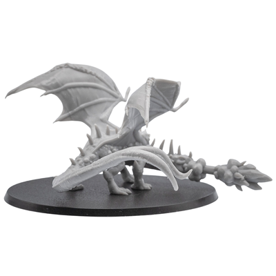 Rear view of an unpainted Fire Breathing Crystal Dragon resin miniature showing raised wings, long tail, and detailed back sculpt.