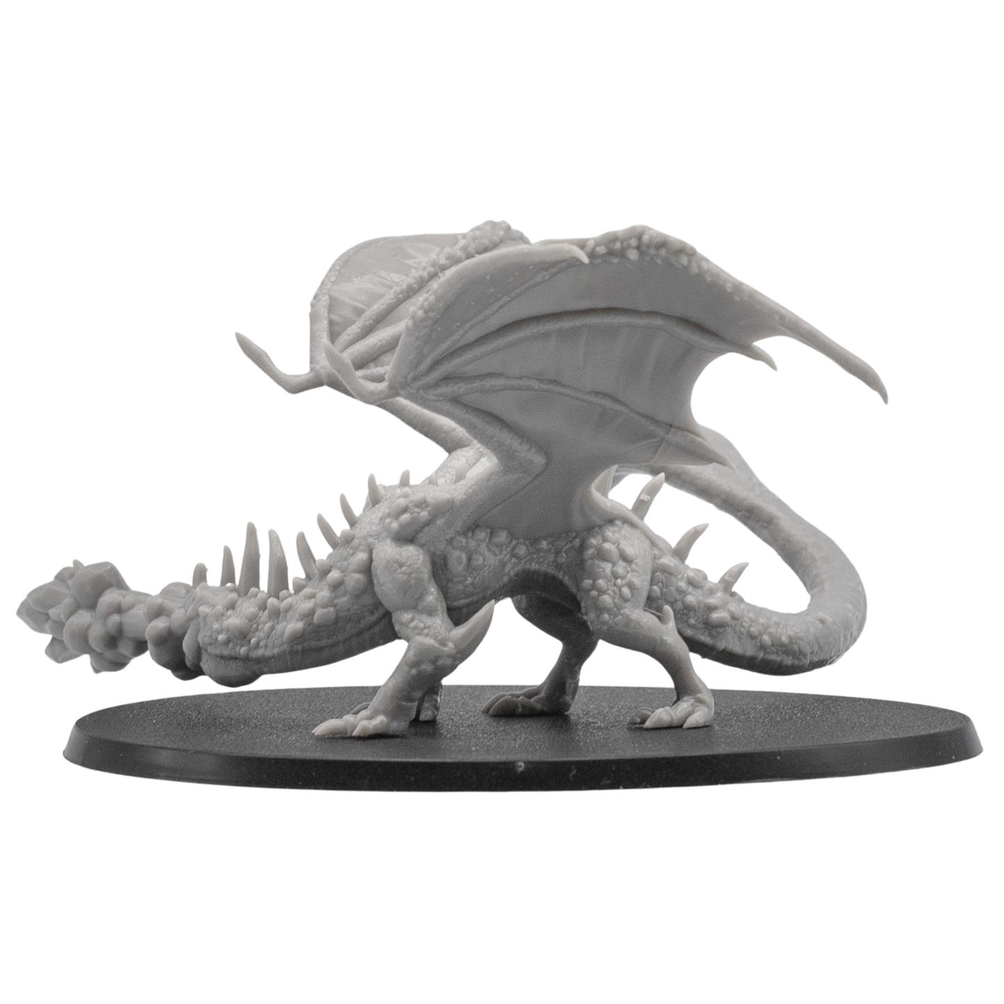 Right side view of an unpainted Fire Breathing Crystal Dragon miniature showing wing membrane detail, long tail, claws, and fire breath effect.