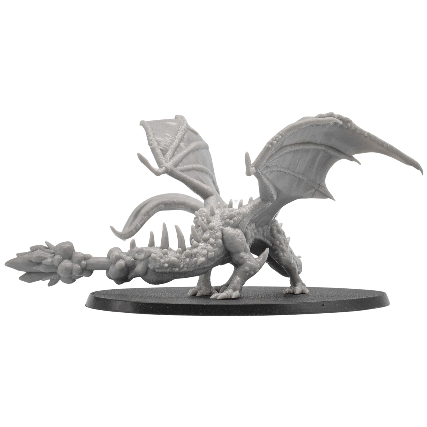 Side view of an unpainted Fire Breathing Crystal Dragon resin miniature by Epic Miniatures showing wings, tail, flame breath, and oval base.