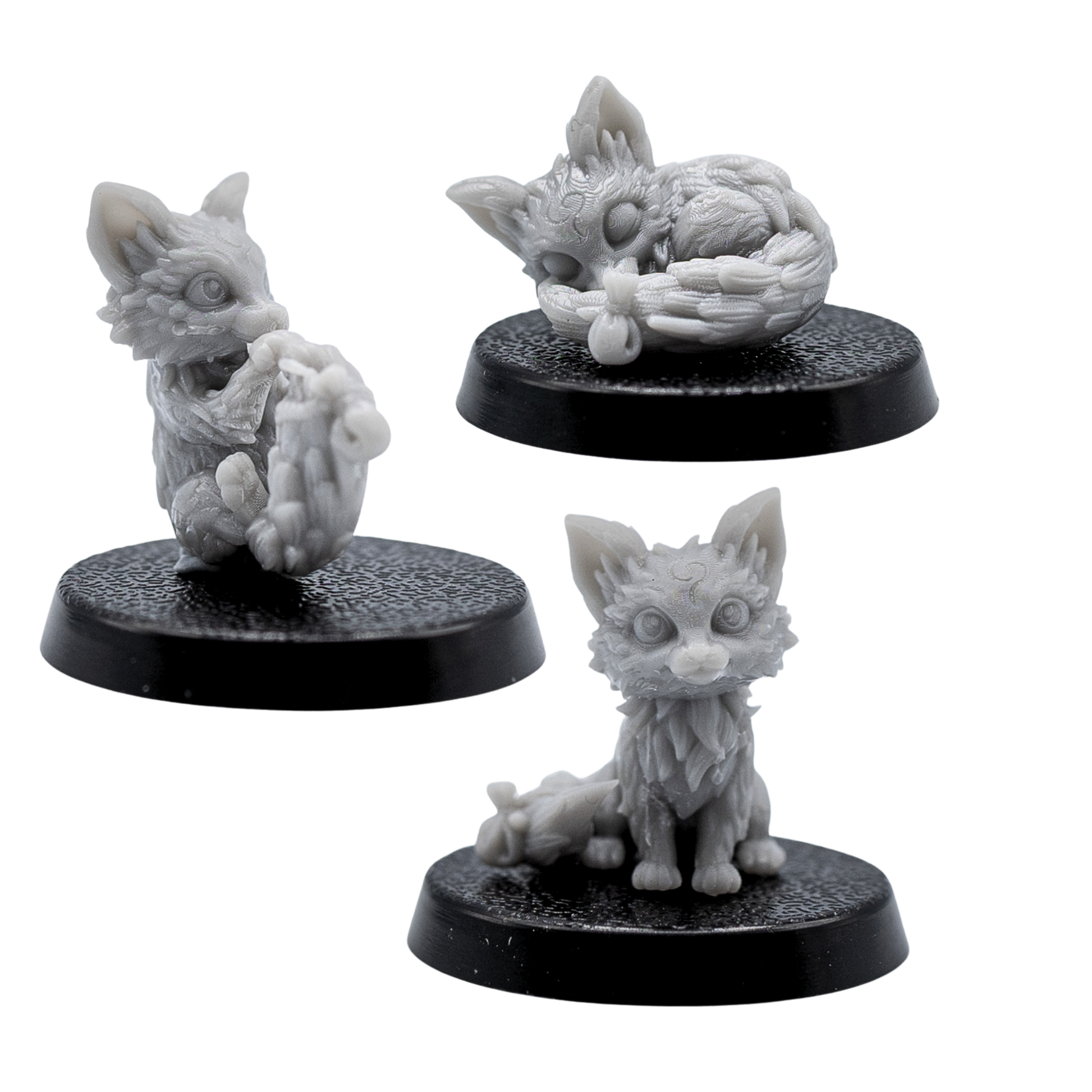 Unpainted Fox Familiars set showing three fox miniatures in sitting, playful, and sleeping poses.